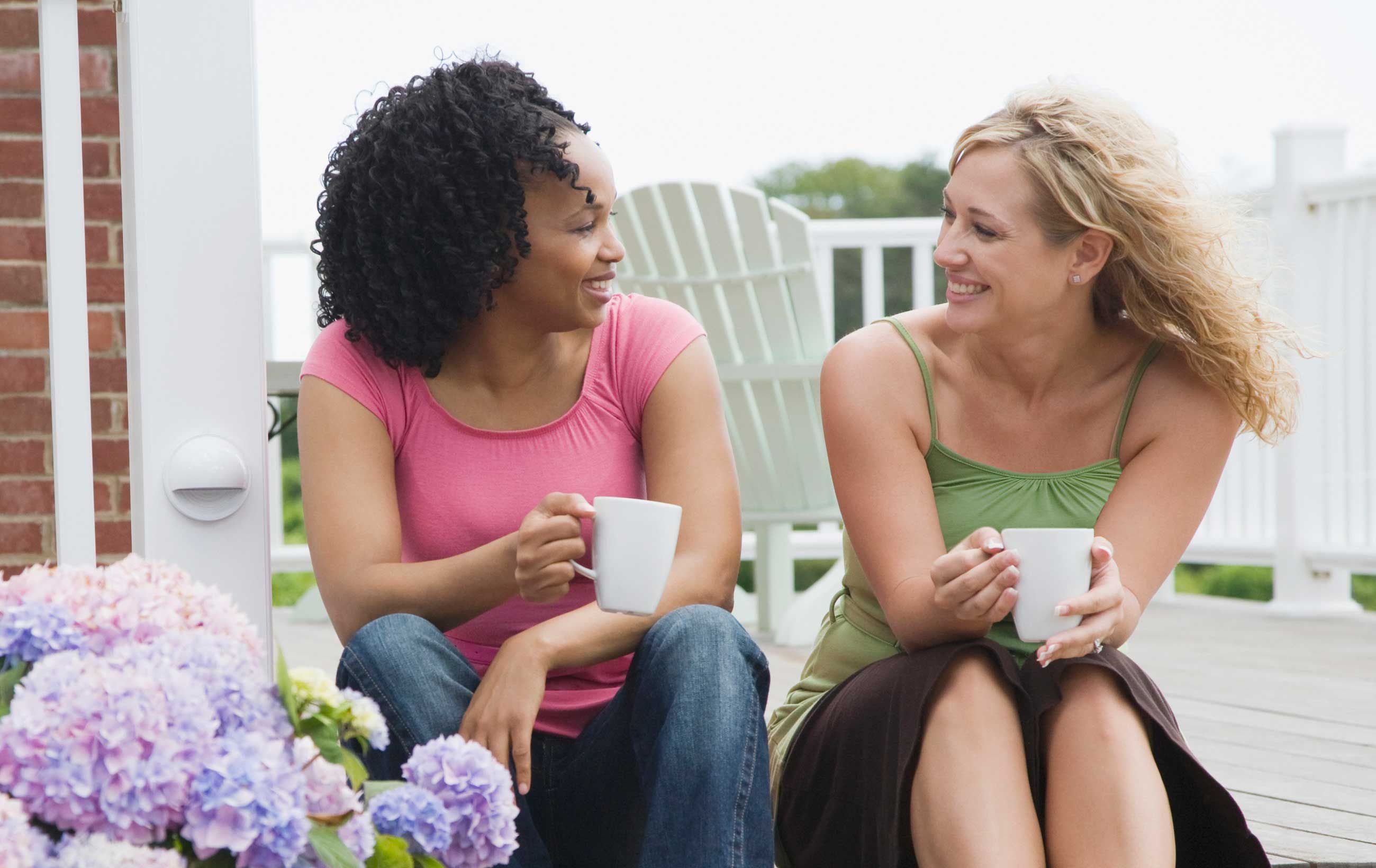 two women talking outdoors