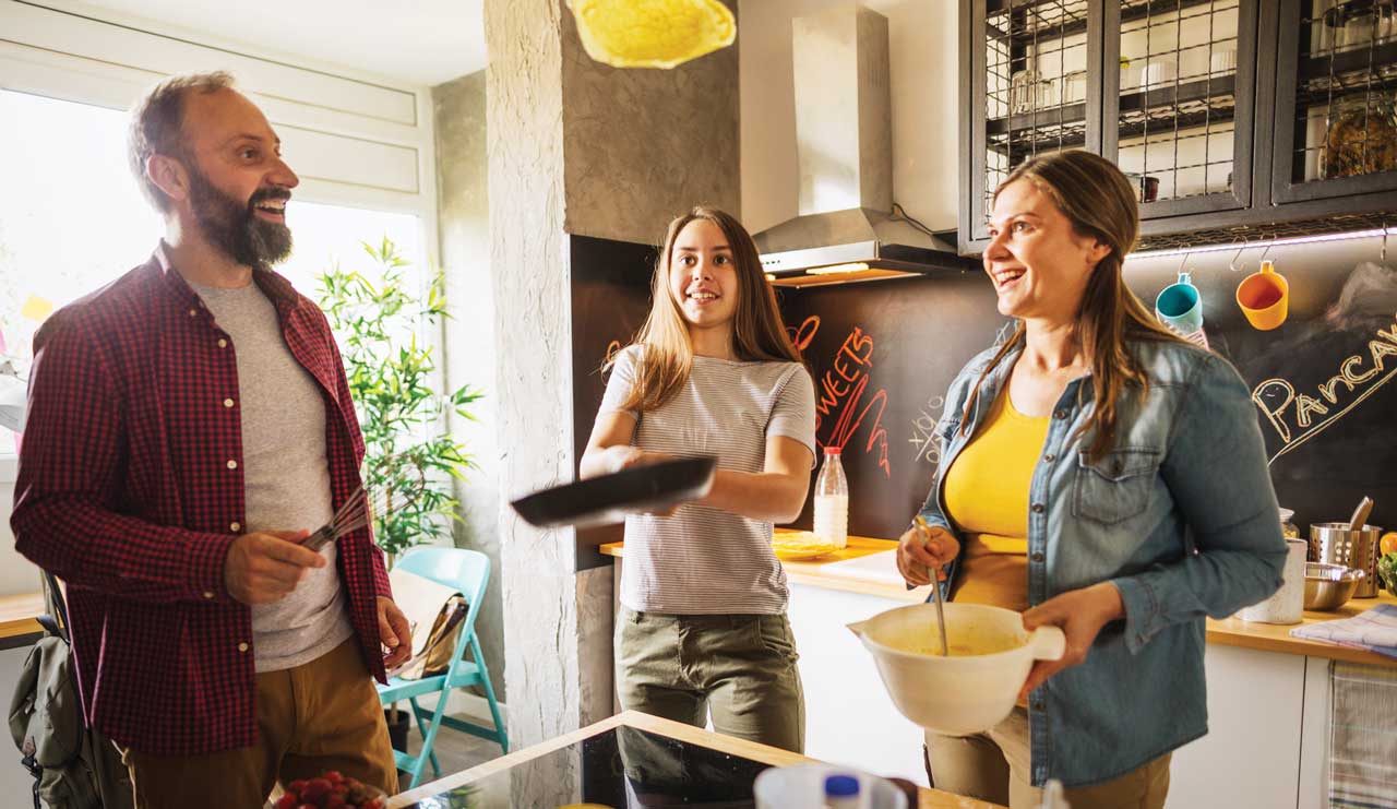 photo of family cooking pancakes together