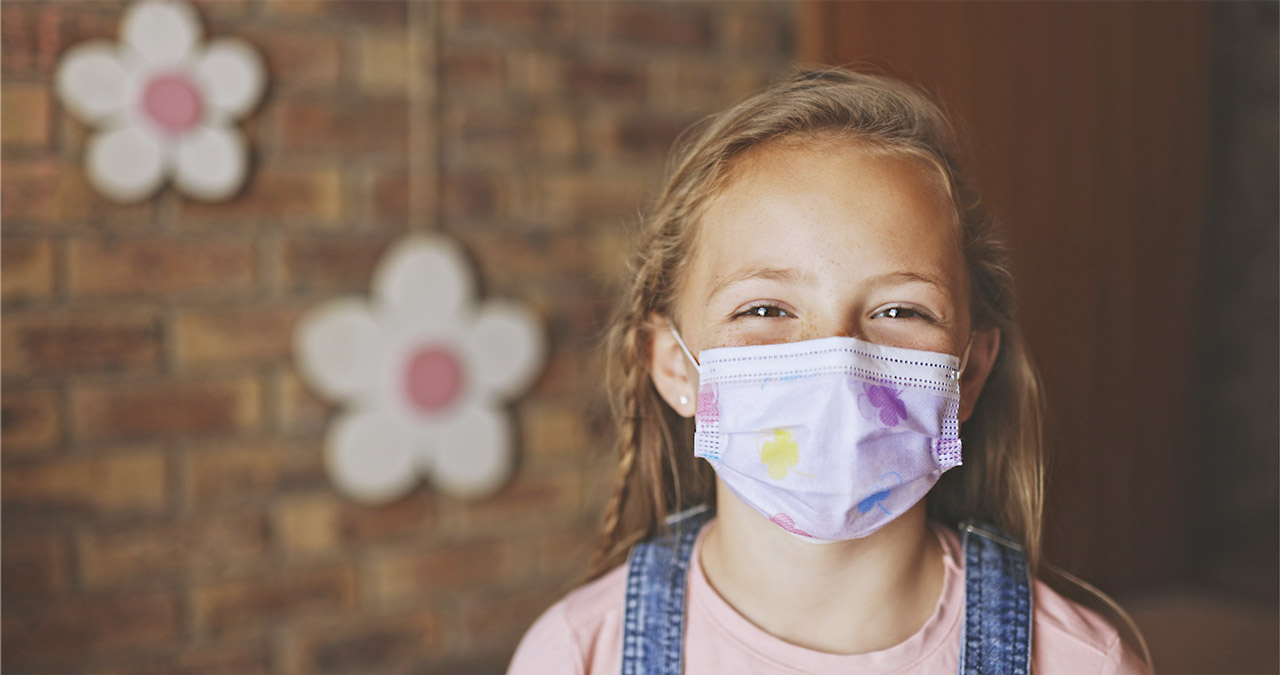 Photo of smiling girl wearing a face mask