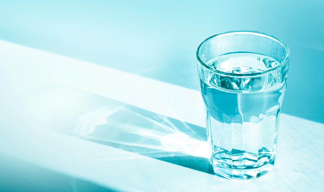 Abstract photo of glass of water with a dramatic, pool-like, shadow