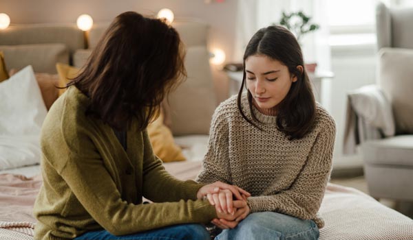 photo of Mother talking with teen child