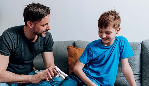 photo of father talking with tween son