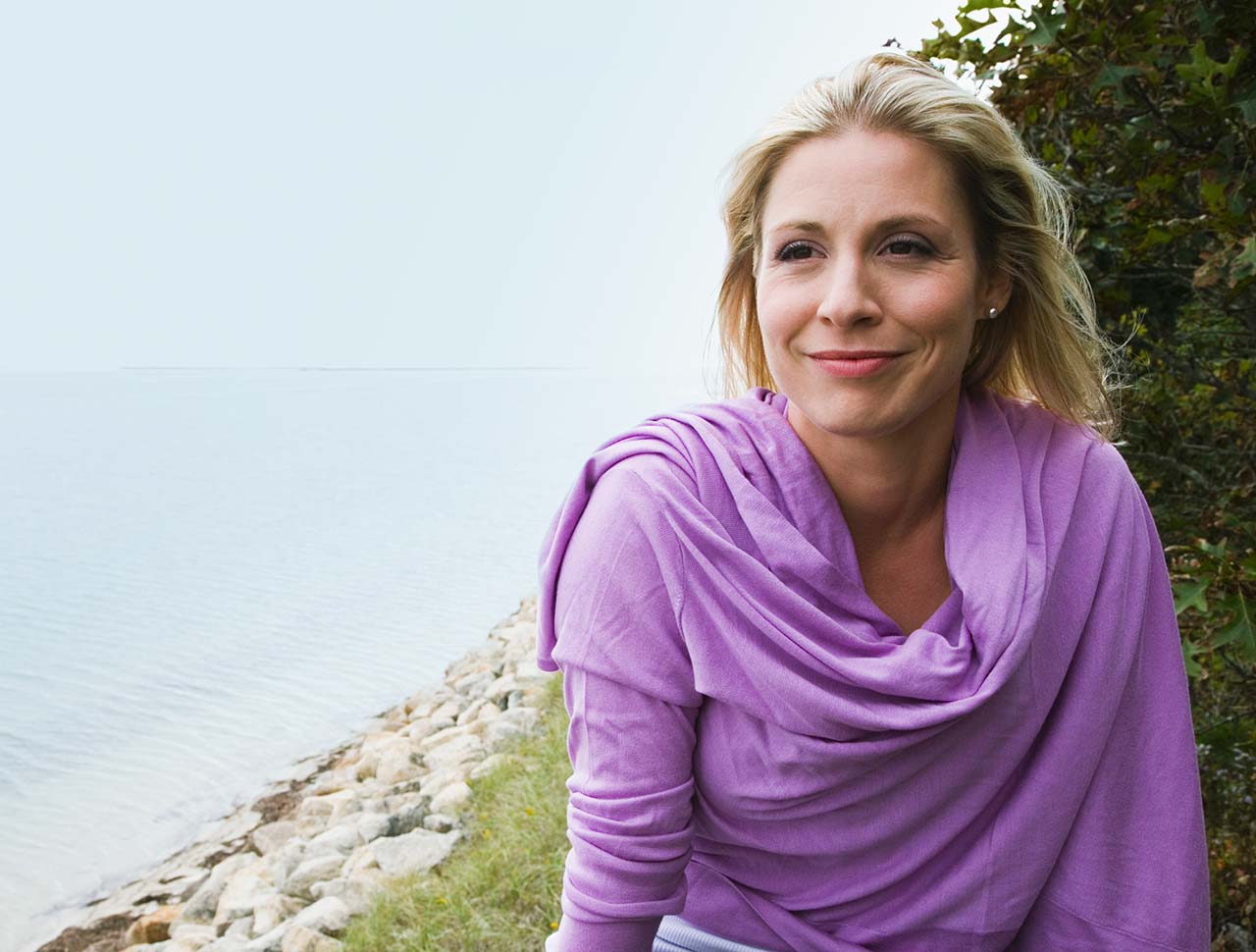 reflective woman at the shore