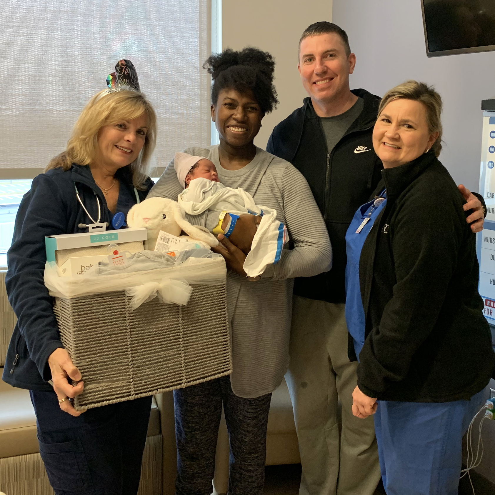 Diana Thibodeau, RN (left) and Jennifer Short, CNM (right) with baby Jemison and parents Nana Wilberforce and Jack Clark