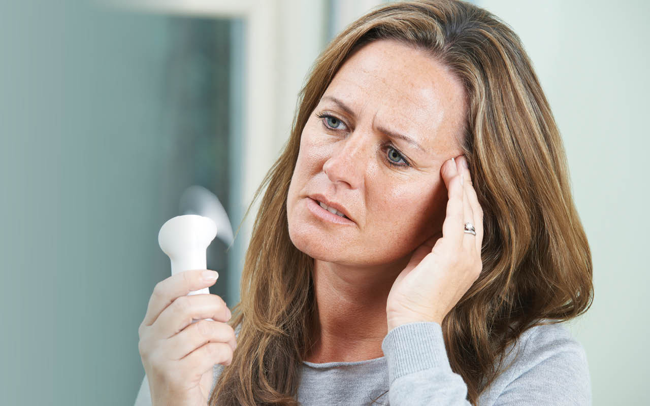Image of woman fanning herself