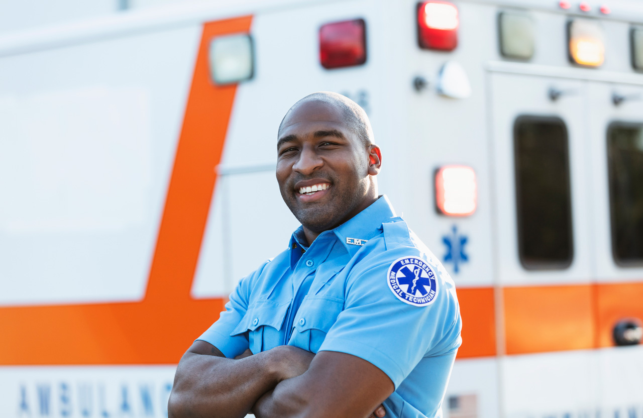 Photo of EMT in front of ambulance