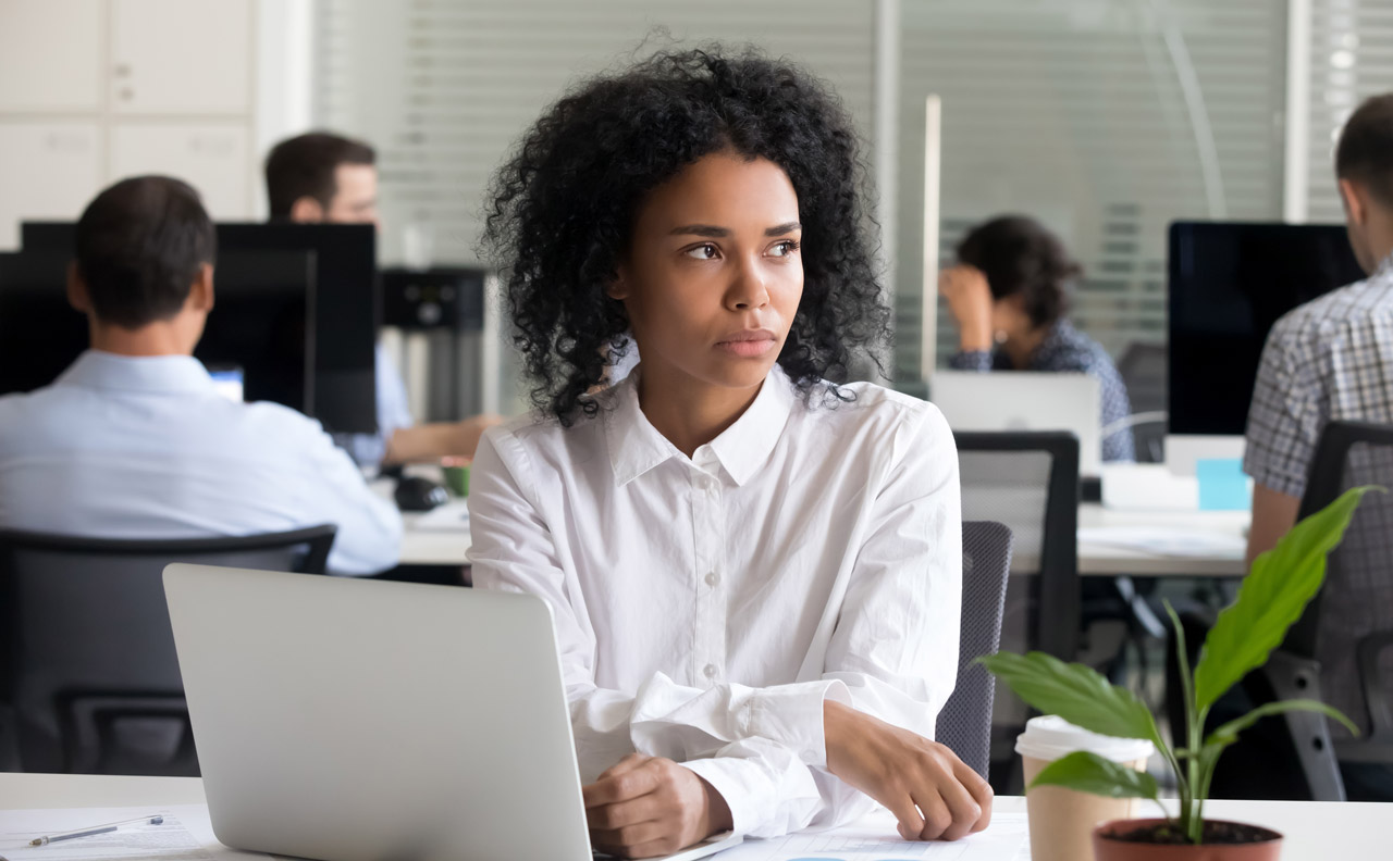 Photo of woman, pensive, at work
