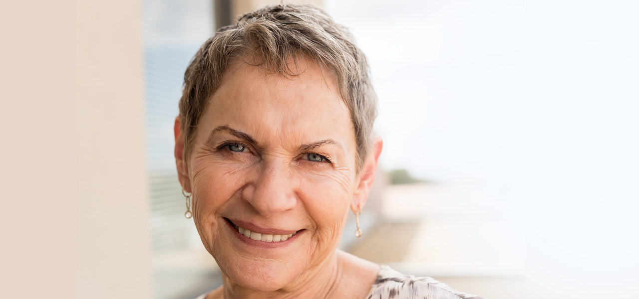 photo of senior woman with cancer smiling