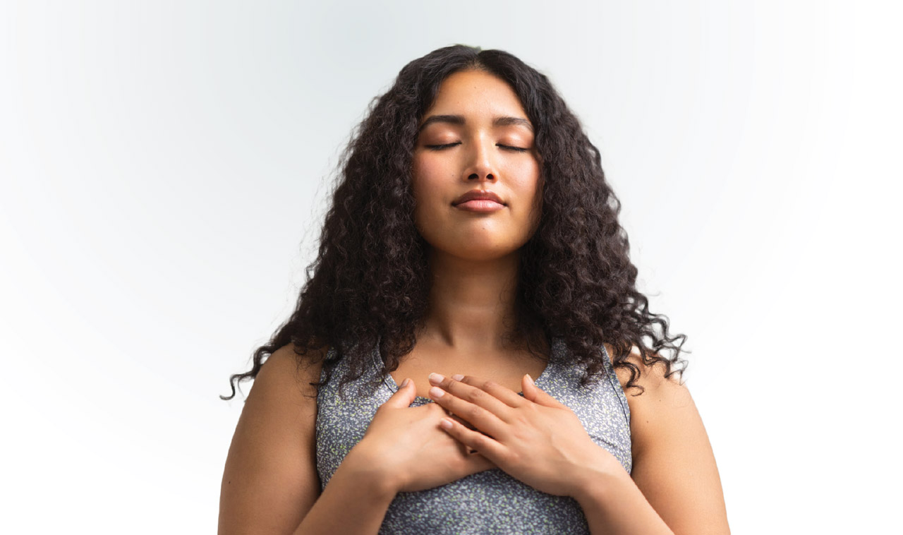 photo of peaceful woman with her hand on her heart