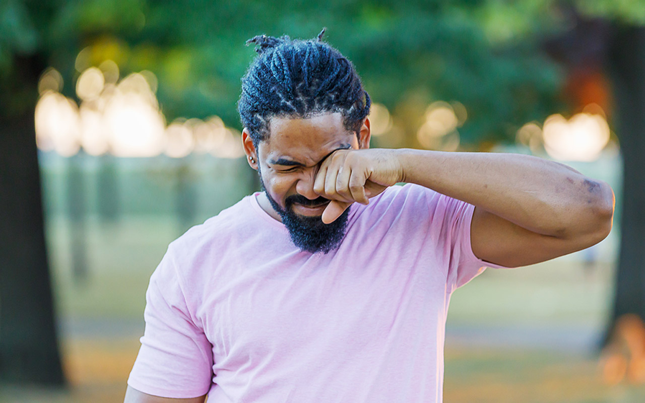 Image of man rubbing his eyes
