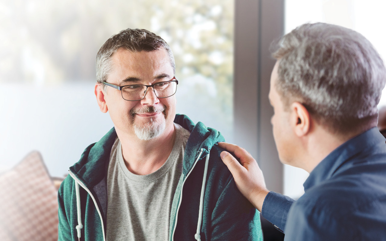 Photo of man being comforted
