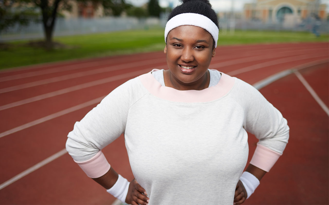 Image of woman getting ready to run on track