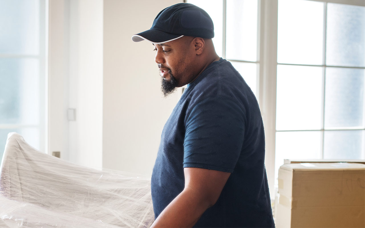 Image of man lifting furniture