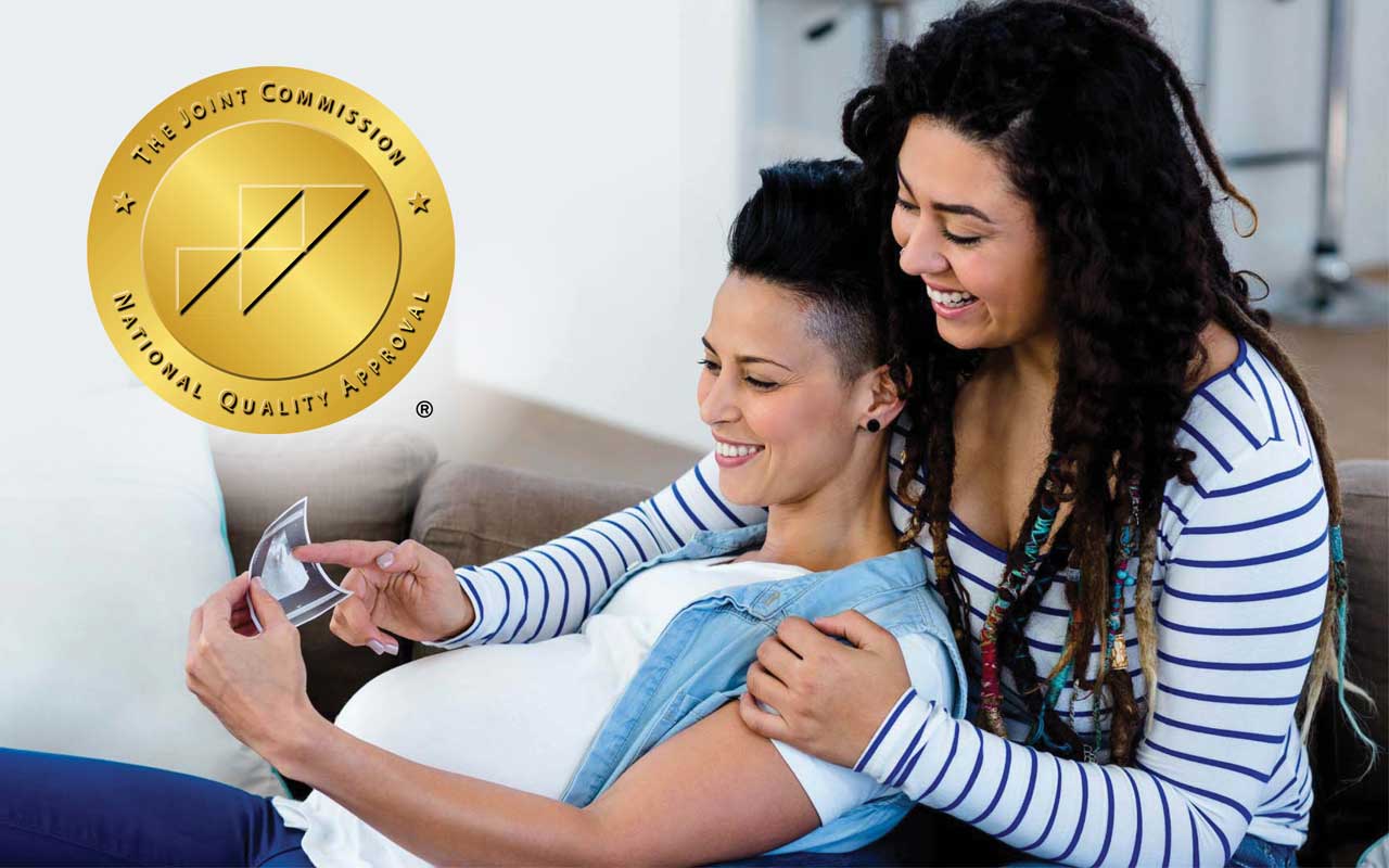 Image of pregnant couple looking at baby's ultrasound