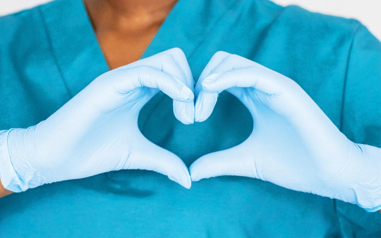 Image of HCP gloved hands forming a heart shape
