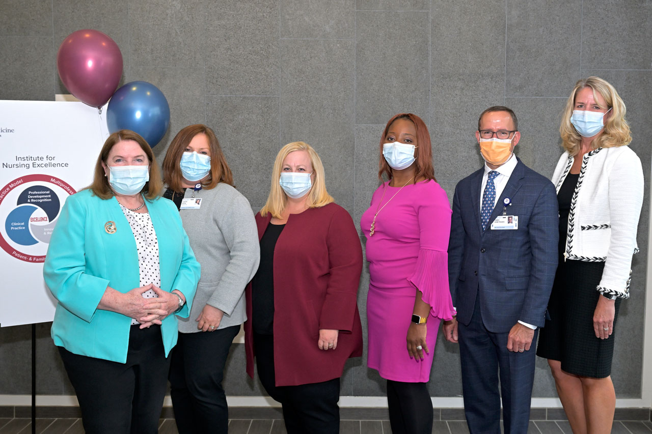 Group photo during opening of Institute for Nursing Excellence. Left to right, Sheila G. Kempf, RN, PhD, NEA-BC, chief nursing officer (CNO); Karyn A. Book, MSN, RN, associate CNO; Kari A. Mastro, PhD, RN, NEA-BC, director of Professional Practice, Innovation, and Research; Nowai Keleekai-Brapoh, PhD, RN, NPD-BC, professional development specialist; James Demetriades, CEO; and Lynda Benton, senior director, global community impact strategic initiatives, Johnson & Johnson Nursing.