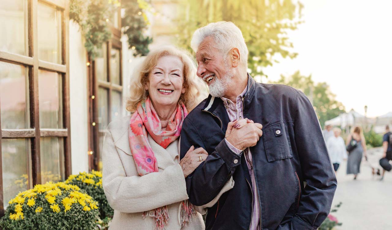 Photo of senior couple walking down the street
