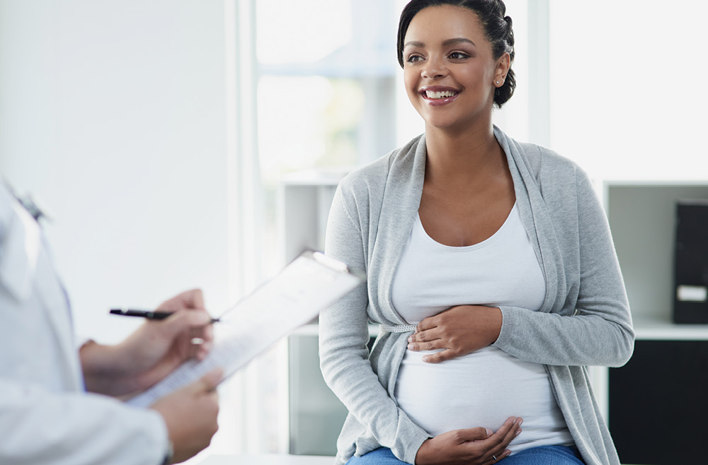 pregnant woman talking to doctor