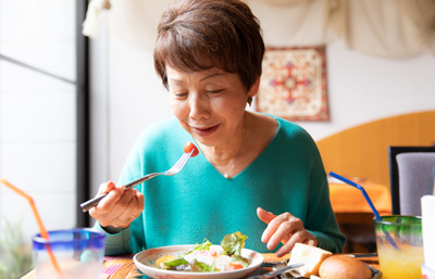 Image of senior woman eating a salad
