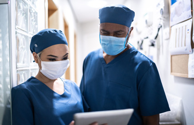 Image of two doctors looking over tablet